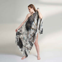 Model wearing the grey and black abstract print scarf as a one-shoulder wrap dress