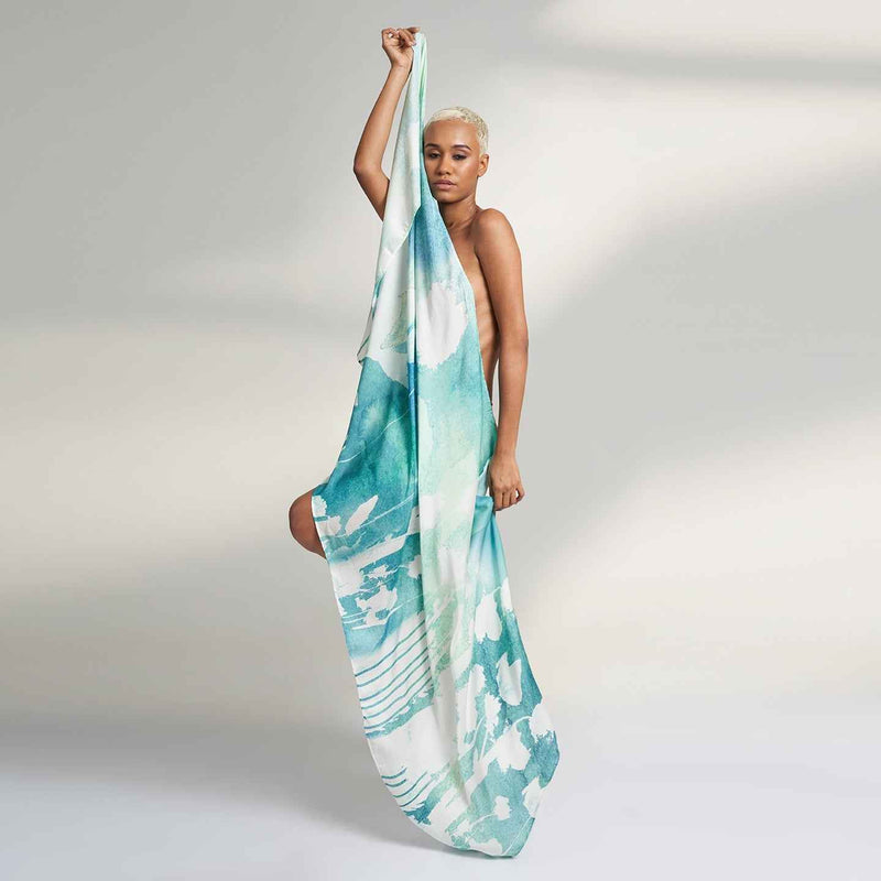 Front view of the model wearing the teal green watercolor print scarf as a wrap dress