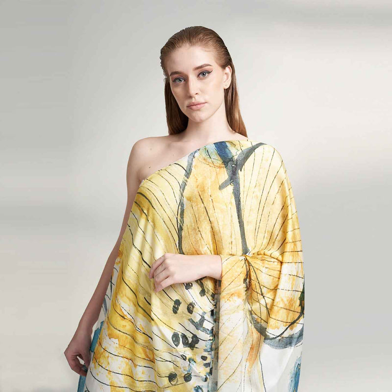 Front view of the model wearing the yellow and blue floral watercolor print scarf as a wrap