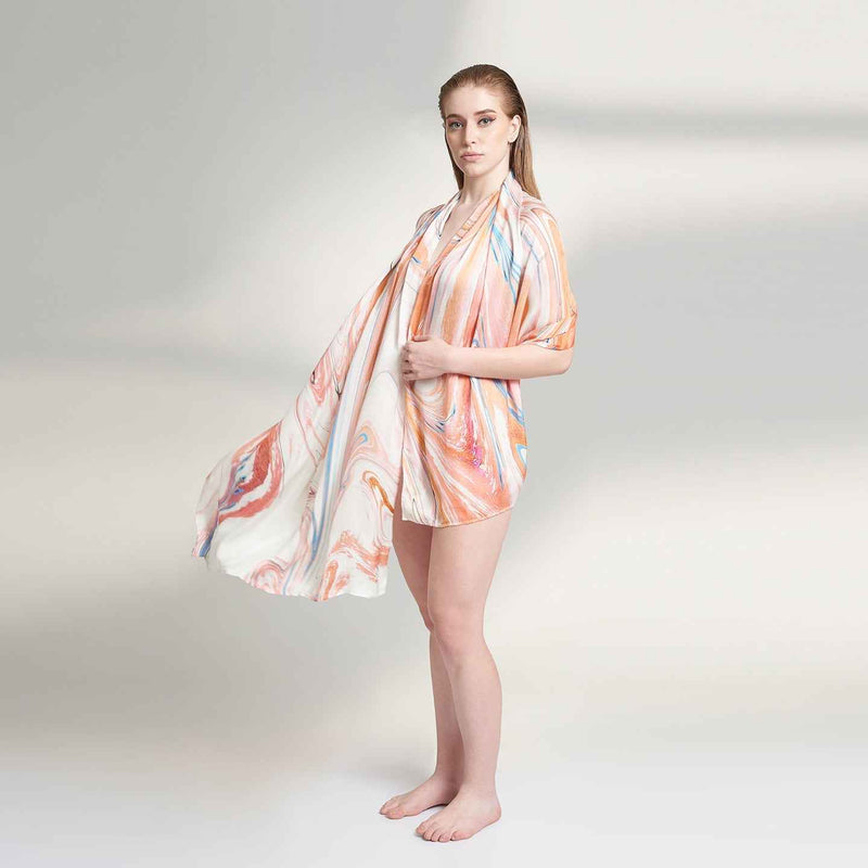 Side view of the model wearing the coral marbled swirl print scarf as a wrap dress