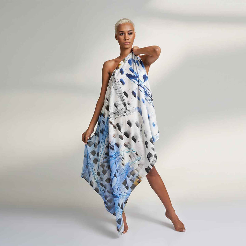 Front view of the model wearing the blue and navy paint-dab print scarf as a wrap dress