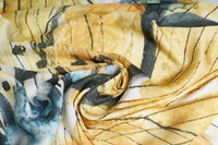 Close-up of the yellow and blue floral watercolor print scarf fabric, gathered