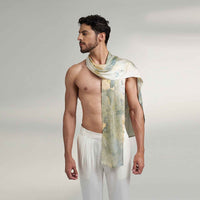 Side view of a man wearing the grey and gold watercolor floral print scarf with white trousers