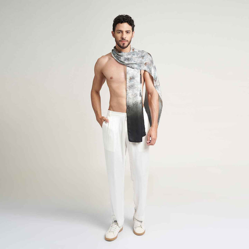 Front view of a man wearing the grey speckled print scarf with white trousers