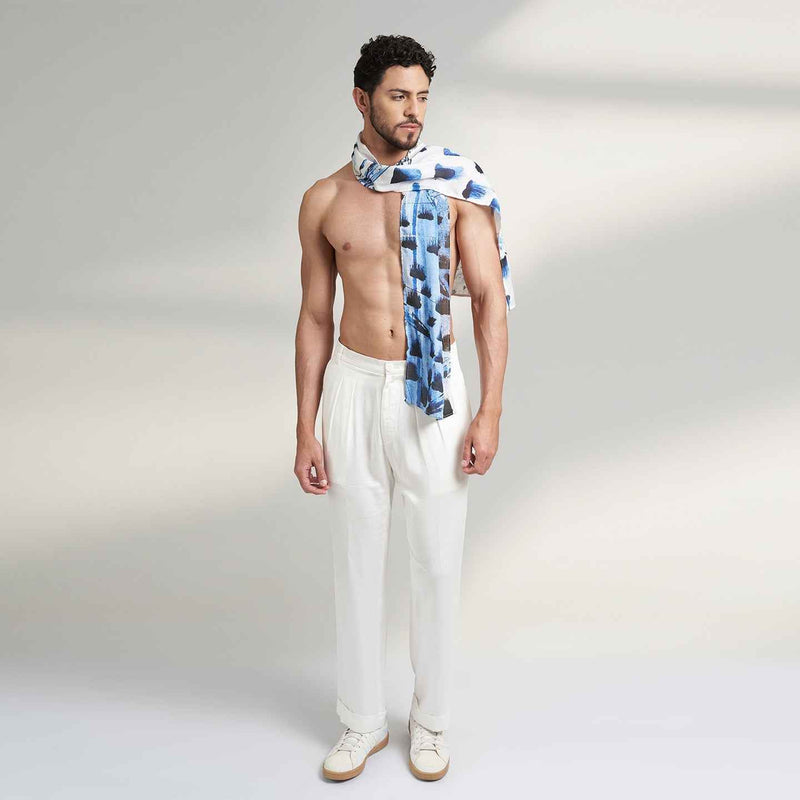 Side view of a man wearing the blue and navy paint-dab print scarf