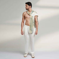 Front view of a man wearing the grey and gold watercolor floral print scarf with white trousers