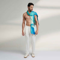 Close-up front view of a man wearing the teal watercolor print scarf