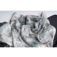 Close-up of the grey speckled print scarf fabric, gathered