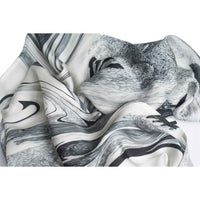 Close-up of the grey and black marbled print scarf fabric, gathered