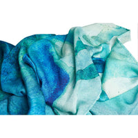 Close-up of the teal watercolor print scarf fabric, gathered