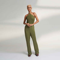 Front view of the olive green wide-leg jumpsuit with a smocked halter bodice