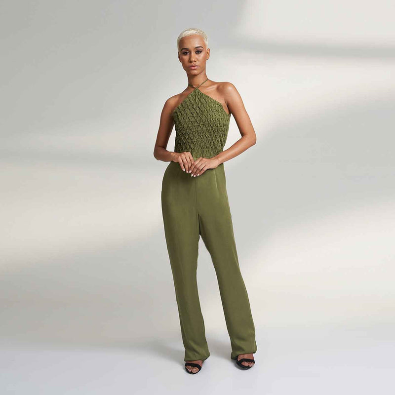 Front view of the olive green wide-leg jumpsuit with a smocked halter bodice