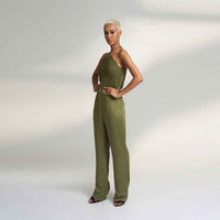 Angled side view of the olive green jumpsuit with a halter neckline