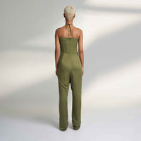 Back view of the olive green jumpsuit showing the tied halter closure