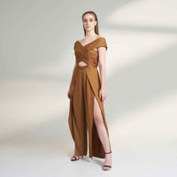 Angled front view of the camel brown jumpsuit with a waist cutout detail