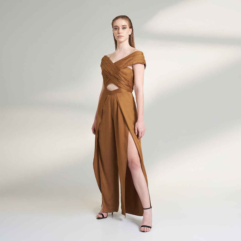Angled front view of the camel brown jumpsuit with a waist cutout detail