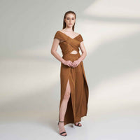 Side view of the camel brown wide-leg jumpsuit showing the front leg slit