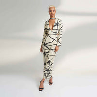 Angled front view of the cream and black print jumpsuit