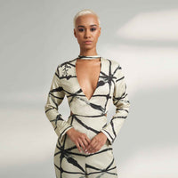 Close-up front view of the cream and black print jumpsuit showing the choker collar and keyhole neckline