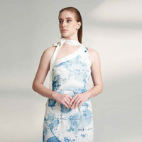 Close-up front view of the blue watercolor print mini dress showing the asymmetric neckline and dotted trim