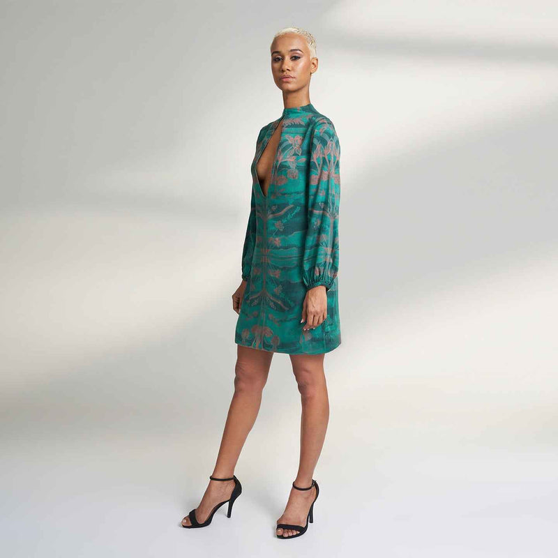 Side view of the green and peach floral print mini dress