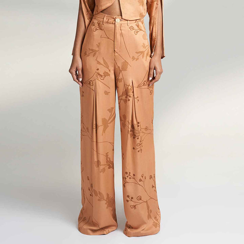 Close-up front view of the peach branch print wide-leg trousers with cargo pocket detail