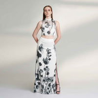 Angled front view of the black and white floral print skirt and matching crop top