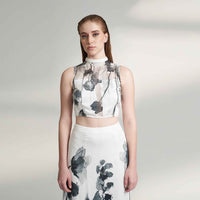 Close-up front view of the black and white floral print crop top and skirt