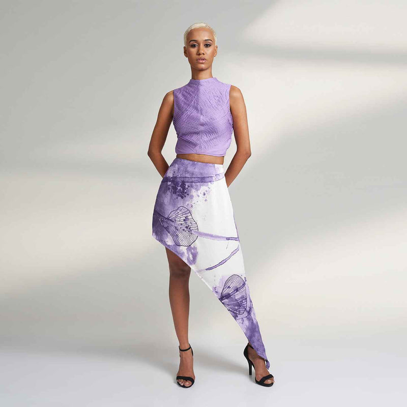 Front view of the asymmetric purple and white floral print skirt, styled with a lilac crop top
