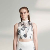 Close-up front view of the black and white floral print crop top