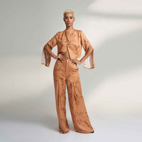 Angled front view of the peach branch print jacket top with matching trousers