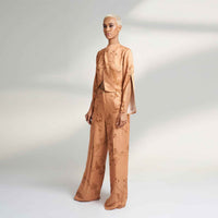 Front view of the peach branch print jacket top and trousers, full length