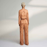Back view of the peach branch print wide-leg trousers and jacket top