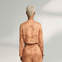 Back view of the peach branch print jacket top and trousers
