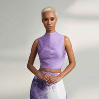 Front view of the pleated lilac purple crop top, styled with a purple and white print skirt