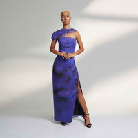 Front view of the long purple tie-dye dress with a one-shoulder lattice trim and side slit