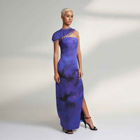 Angled side view of the long purple tie-dye dress with a one-shoulder lattice trim