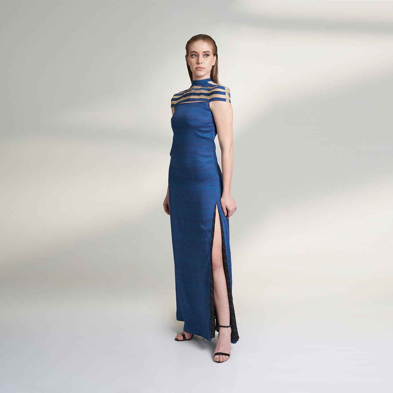 Angled front view of the long navy blue dress with a sheer striped neckline