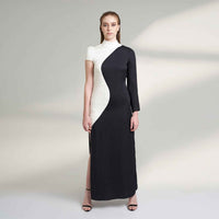 Front view of the long black and white colorblock dress with asymmetric sleeves