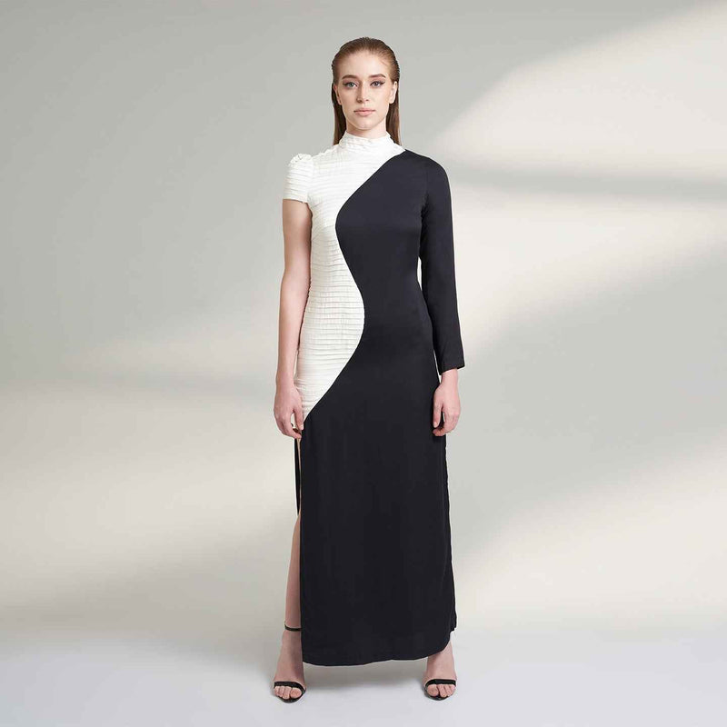 Front view of the long black and white colorblock dress with asymmetric sleeves