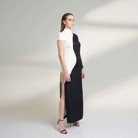 Side view of the long black and white colorblock dress showing the side slit