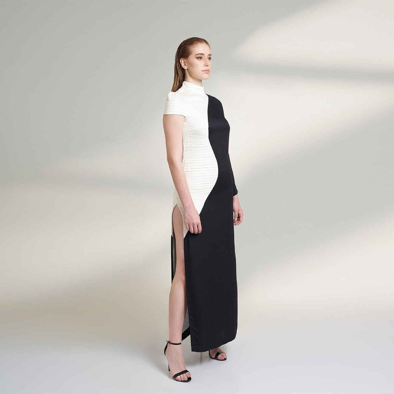 Side view of the long black and white colorblock dress showing the side slit