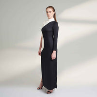 Angled side view of the long black and white colorblock dress