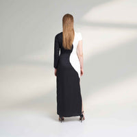 Back view of the long black and white colorblock dress showing the side slit