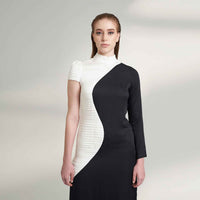 Close-up front view of the black and white colorblock dress showing the swirled panel detail