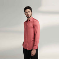 Angled front view of the solid crimson red shirt styled with black trousers
