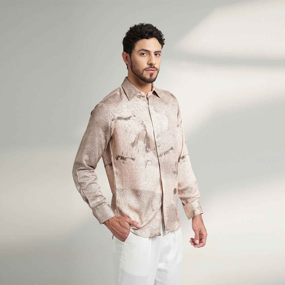 Angled front view of the blush pink speckled print shirt styled with white trousers