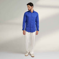 Front view of the solid royal blue shirt and white trousers