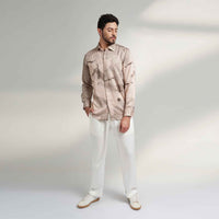 Front view of the blush pink speckled print shirt and white trousers