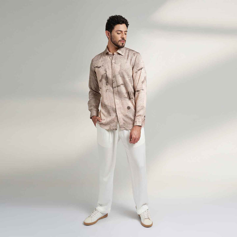 Front view of the blush pink speckled print shirt and white trousers